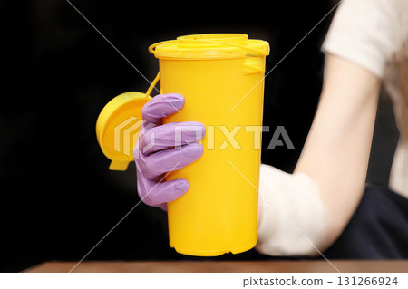 Plastic medical waste container in hand Plastic medical waste container in hand 131266924