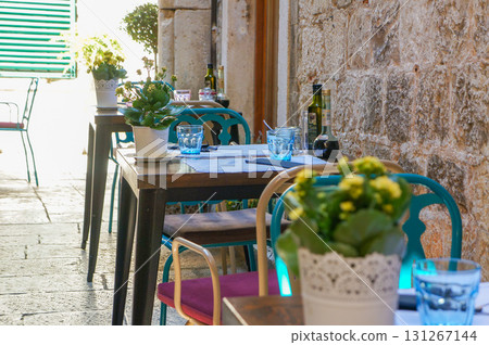 Shaded terrace seating on the side street of the restaurant Shaded terrace seating on the side street of the restaurant 131267144