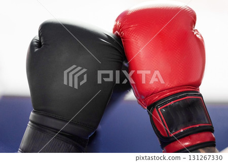 Boxing gloves touching, ready to start de combat.  131267330
