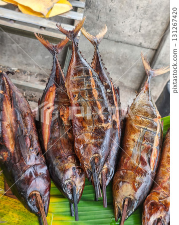 Smoked fish skewers on a banana leaf, a popular street food delicacy in Surabaya, Indonesia. Golden-brown and appetizing. 131267420