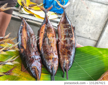 Smoked fish skewers on a banana leaf, a popular street food delicacy in Surabaya, Indonesia. Golden-brown and appetizing. 131267421