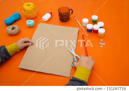 Create a fish sculpture from cardboard, thread, and paint, with step-by-step guidance, set against an orange background. Create a fish sculpture from cardboard, thread, and paint, with step-by-step guidance, set against an orange background. 131267716