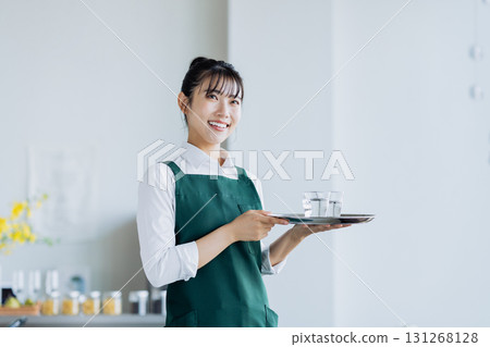A young woman working in a cafe A young woman working in a cafe 131268128