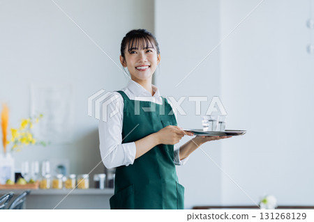 A young woman working in a cafe 131268129