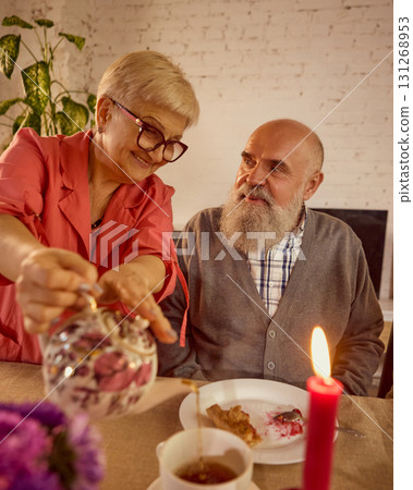 Elderly couple enjoying tea together in tender emotional family setting Elderly couple enjoying tea together in tender emotional family setting 131268953