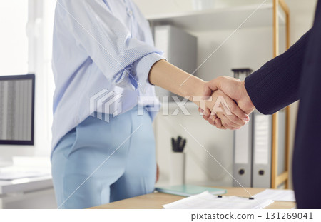 Close Up Of Businesswoman Shaking Hands With Client Or Colleague In Office Close Up Of Businesswoman Shaking Hands With Client Or Colleague In Office 131269041