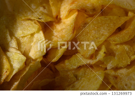 Deliciously crispy potato chips scattered in a bowl, perfect for snack time 131269973