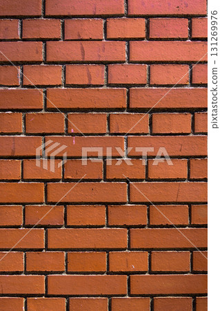 Vibrant red brick wall texture showcasing craftsmanship and architectural details in a rustic environment Vibrant red brick wall texture showcasing craftsmanship and architectural details in a rustic environment 131269976