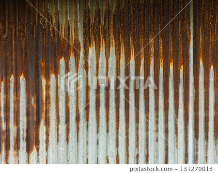 Rust patterns on a metallic surface illuminated by soft sunlight in an urban setting 131270013