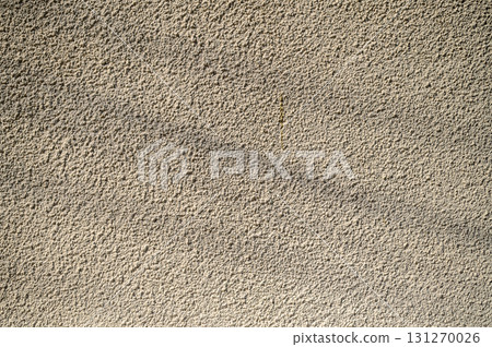 Textured wall illuminated by soft sunlight, showcasing intricate patterns and subtle shadows Textured wall illuminated by soft sunlight, showcasing intricate patterns and subtle shadows 131270026