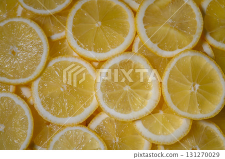 Freshly sliced lemons create a vibrant display of yellow on a sunny kitchen counter Freshly sliced lemons create a vibrant display of yellow on a sunny kitchen counter 131270029