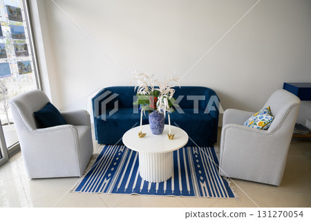 Cozy modern living area showcasing stylish furniture and vibrant decor for a welcoming atmosphere Cozy modern living area showcasing stylish furniture and vibrant decor for a welcoming atmosphere 131270054