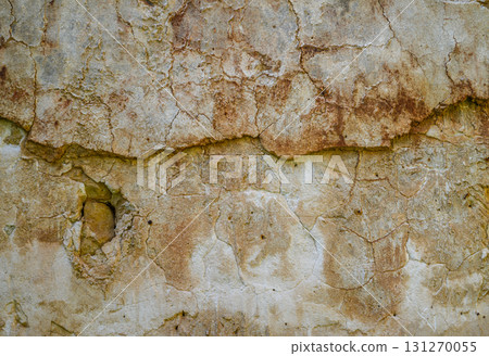 Textured wall revealing nature's artistry through weathered cracks at an old building Textured wall revealing nature's artistry through weathered cracks at an old building 131270055