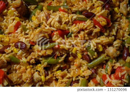 Savory rice dish filled with colorful vegetables and tender meat prepared Savory rice dish filled with colorful vegetables and tender meat prepared 131270096