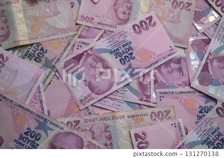 Colorful banknotes of Turkish Lira scattered on a table during a sunny afternoon Colorful banknotes of Turkish Lira scattered on a table during a sunny afternoon 131270138