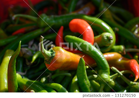 Freshly harvested chili peppers at a vibrant local market in the heart of summer Freshly harvested chili peppers at a vibrant local market in the heart of summer 131270150