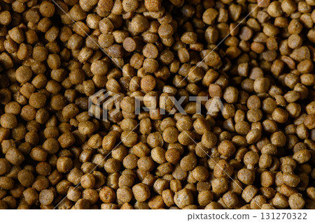 Unique look at dry pet food in a vibrant texture captured indoors during daylight hours Unique look at dry pet food in a vibrant texture captured indoors during daylight hours 131270322