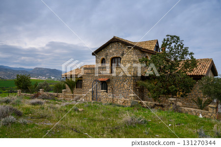 Stone house abandoned in a tranquil countryside setting with mountains Stone house abandoned in a tranquil countryside setting with mountains 131270344