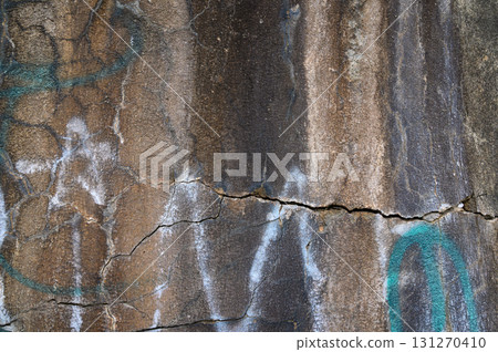 Exploring the textures and colors of weathered stone with intricate markings and cracks Exploring the textures and colors of weathered stone with intricate markings and cracks 131270410