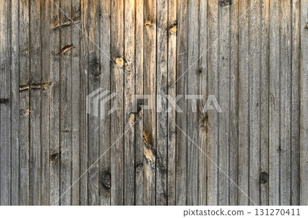 Weathered wooden wall exudes rustic charm and timeless beauty in soft evening light 131270411