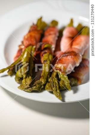 Deliciously wrapped asparagus with savory bacon on a stylish plate 131270440