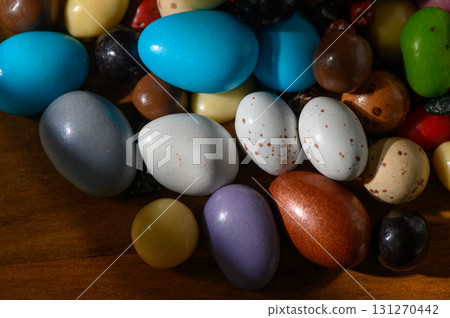 Colorful collection of decorative eggs arranged on wooden surface in soft 131270442