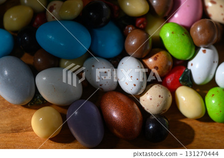 Colorful assortment of decorative eggs spread across a wooden surface during Colorful assortment of decorative eggs spread across a wooden surface during 131270444