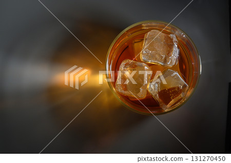 Refreshing iced tea in a clear glass on a dark surface, capturing the essence Refreshing iced tea in a clear glass on a dark surface, capturing the essence 131270450