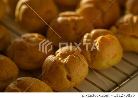 Golden pastry balls cooling on a wire rack after baking in a cozy kitchen 131270850
