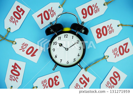 Clock surrounded by various discount tags with percentages like 10%, 20%, 30%, up to 90% off, set against a bright blue background Clock surrounded by various discount tags with percentages like 10%, 20%, 30%, up to 90% off, set against a bright blue background 131271959