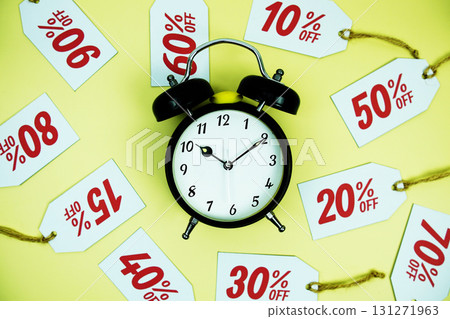 Clock surrounded by various discount tags with percentages like 10%, 20%, 30%, up to 90% off, set against a bright yellow background Clock surrounded by various discount tags with percentages like 10%, 20%, 30%, up to 90% off, set against a bright yellow background 131271963