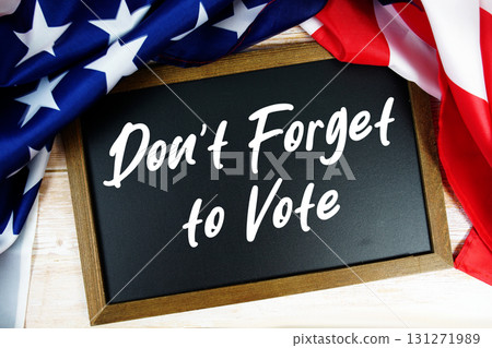 American flag with blackboard  "Don't Forget to Vote" on wooden background 131271989