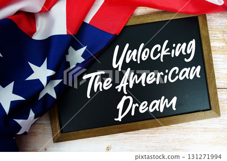 American flag with blackboard "Unlocking the American Dream" on wooden background American flag with blackboard "Unlocking the American Dream" on wooden background 131271994