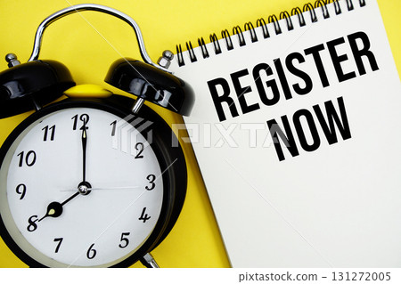 Register Now text with alarm clock flat lay on yellow background Register Now text with alarm clock flat lay on yellow background 131272005