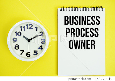 Business Process Owner text with alarm clock flat lay on yellow background Business Process Owner text with alarm clock flat lay on yellow background 131272010