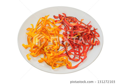 Freeze-dried vegetable for travel. Dried sweet peppers on a ceramic plate isolated on a white background. Various dry of sweet peppers. 131272103