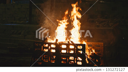 Varanasi, Uttar Pradesh, India. Fire burn faster during a funeral cremation ceremony on Harishchandra Ghat. Harishchandra Ghat is one of the only two ghats serving as cremation sites along Ganges Varanasi, Uttar Pradesh, India. Fire burn faster during a funeral cremation ceremony on Harishchandra Ghat. Harishchandra Ghat is one of the only two ghats serving as cremation sites along Ganges 131272127