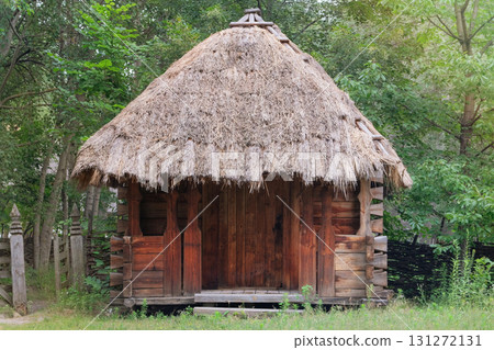 Aged wooden peasant house. Retro roof. Ancient countryside cottage. Old thatched roof. Sunny day. Aged wooden peasant house. Retro roof. Ancient countryside cottage. Old thatched roof. Sunny day. 131272131