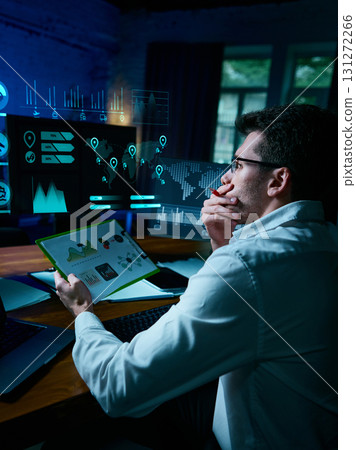 Professional analyst reviewing digital data dashboards with futuristic projections. Collage 131272266