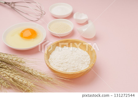 Cooking and baking image (flour, eggs, salt, brown sugar, wheat ears) pink background Cooking and baking image (flour, eggs, salt, brown sugar, wheat ears) pink background 131272544