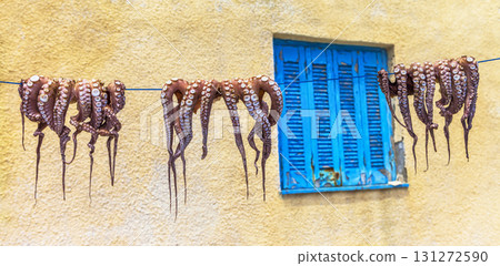 traditions of Greek cuisine - octopus drying in sun 131272590