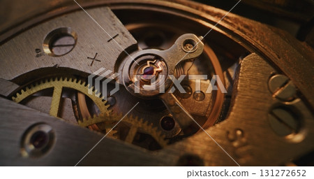 Macro Shot of Mechanical Clock Movement Showing Gears, Wheels and Balance Mechanism Macro Shot of Mechanical Clock Movement Showing Gears, Wheels and Balance Mechanism 131272652
