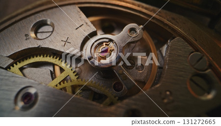 Macro Close Up Shot of Intricate Watch Mechanism with Moving Gears and Balance Wheel Macro Close Up Shot of Intricate Watch Mechanism with Moving Gears and Balance Wheel 131272665