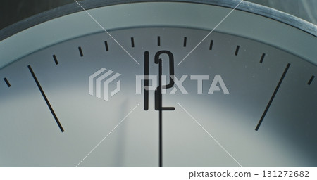 Macro Close Up Shot of Number 12 on the Dial and Running Second Hand on Minimalist Wall Clock 131272682