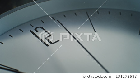 Macro Close Up Shot of Minimalist Wall Clock with Number 12 on the Dial and Running Second Hand 131272688