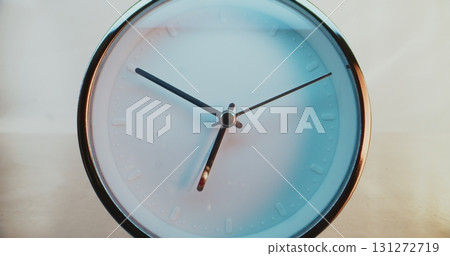 Close Up of Minimalist Round Wall Clock on Warm Background Showing Precise Time Close Up of Minimalist Round Wall Clock on Warm Background Showing Precise Time 131272719