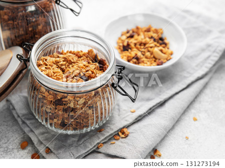 Granola cereal in glass jar ready for healthy breakfast Granola cereal in glass jar ready for healthy breakfast 131273194