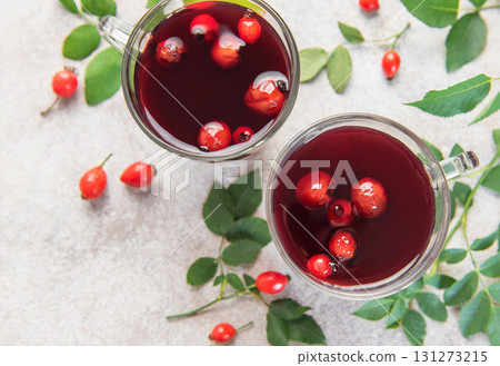 Drinking hot rosehip tea with berries and leaves Drinking hot rosehip tea with berries and leaves 131273215