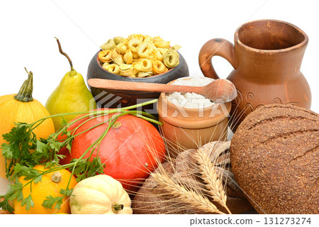 Rustic Still Life with Autumn Harvest Food, Including Pumpkins, Fresh Bread, and Pasta on a White Background 131273274