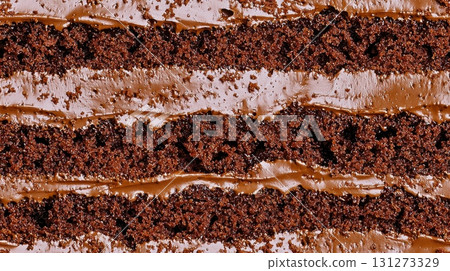 Close up of layered chocolate cake with creamy filling texture background 131273329